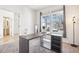Cozy home office with a stylish desk, ample natural light from the windows, and view to the ensuite powder room at 4844 Mt Evans St, Brighton, CO 80601