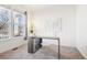 Bright home office with large window, modern desk, and neutral decor, perfect for working from home at 4844 Mt Evans St, Brighton, CO 80601