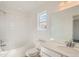 Spotless bathroom featuring white tile, modern fixtures, and a large vanity mirror at 13729 Daffodil Pt, Parker, CO 80134