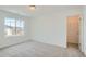 Well-lit bedroom with neutral carpet, ample space, and a closet for storage at 13729 Daffodil Pt, Parker, CO 80134