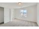Bright bedroom featuring a plush carpet, large window providing natural light, and a closet at 13729 Daffodil Pt, Parker, CO 80134