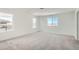 Spacious bedroom with multiple windows, neutral carpeting, and plenty of natural light at 13729 Daffodil Pt, Parker, CO 80134