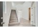 Light filled entryway with beautiful staircase and durable light colored floors at 13729 Daffodil Pt, Parker, CO 80134
