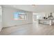 Bright living room featuring durable light colored flooring, an open concept layout, and large sunny windows at 13729 Daffodil Pt, Parker, CO 80134