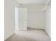 Open walk-in closet with neutral carpet, open door, and minimalist hanging racks at 13729 Daffodil Pt, Parker, CO 80134
