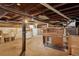 Spacious unfinished basement with exposed wood ceiling and old cabinetry providing a blank canvas for customization at 1900 S University Blvd, Denver, CO 80210