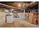Unfinished basement with exposed beams, concrete floor, and old cabinets ready for your imagination and renovation at 1900 S University Blvd, Denver, CO 80210