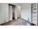 Bedroom with closet and built-in shelving undergoing renovation with natural light at 1900 S University Blvd, Denver, CO 80210