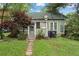 Charming green single Gathering home, front lawn and stone sidewalk, awaiting your creative vision and updates at 1900 S University Blvd, Denver, CO 80210