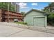 Green garage with apartment building in the background showcasing its location and surrounding amenities at 1900 S University Blvd, Denver, CO 80210
