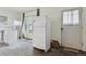 Spacious kitchen featuring a white refrigerator, a side entrance door, and many windows at 1900 S University Blvd, Denver, CO 80210