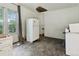 A spacious kitchen with a white refrigerator, light fixture, and a hole in the ceiling at 1900 S University Blvd, Denver, CO 80210