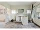 Open living room featuring bright windows, an ornate fireplace, and access to the stairs at 1900 S University Blvd, Denver, CO 80210
