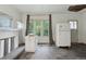Open living room with windows, fireplace, and kitchen features in need of renovation at 1900 S University Blvd, Denver, CO 80210