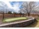 Backyard putting green with stone retainer wall and wooden fence at 16658 E 106Th Dr, Commerce City, CO 80022