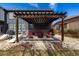 Cozy backyard patio with an outdoor seating and pergola at 16658 E 106Th Dr, Commerce City, CO 80022