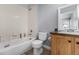 Bathroom showcasing a tub with shower, toilet and a wood vanity at 16658 E 106Th Dr, Commerce City, CO 80022