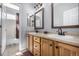 Bathroom featuring double vanity with a wood cabinets and a separate room for toilet and shower at 16658 E 106Th Dr, Commerce City, CO 80022