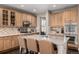 Bright kitchen featuring a center island with bar seating, stainless steel appliances and light wood cabinets at 16658 E 106Th Dr, Commerce City, CO 80022