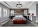 Stylish main bedroom with a reclaimed wood accent wall, and a beverage center at 16658 E 106Th Dr, Commerce City, CO 80022