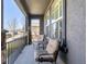 Inviting outdoor seating area on a cozy covered porch with nice chairs and a small table to enjoy your morning coffee at 16658 E 106Th Dr, Commerce City, CO 80022