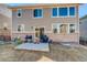 Backyard view showcasing the house's patio, grill, and spacious grassy area at 26881 E Roxbury Pl, Aurora, CO 80016