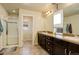Spacious bathroom features dual sinks, a walk-in shower, and tile floors at 26881 E Roxbury Pl, Aurora, CO 80016