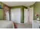 Cozy bedroom with olive green walls, closet, and doorway leading to the hall at 26881 E Roxbury Pl, Aurora, CO 80016