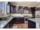 Beautiful kitchen featuring stainless steel appliances, granite countertops, and dark wood cabinets at 26881 E Roxbury Pl, Aurora, CO 80016