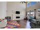 Spacious living room with a soaring ceiling, modern fireplace, and lots of natural light at 26881 E Roxbury Pl, Aurora, CO 80016