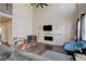 Bright, open living room with soaring ceilings, a fireplace, and hardwood floors at 26881 E Roxbury Pl, Aurora, CO 80016