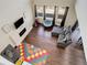 Sun-drenched living room showcases hardwood floors, large windows, a fireplace, and comfortable seating at 26881 E Roxbury Pl, Aurora, CO 80016