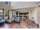 Bright open-concept living room with hardwood floors and large windows showcasing natural light at 26881 E Roxbury Pl, Aurora, CO 80016