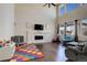 Bright living room with high ceilings, fireplace, and large windows offering natural light at 26881 E Roxbury Pl, Aurora, CO 80016