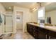 Well-lit main bathroom with a double vanity, shower, and separate toilet for added convenience at 26881 E Roxbury Pl, Aurora, CO 80016