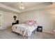 Spacious main bedroom boasts soft carpeting, neutral paint, and a beautiful floral pattern bedspread at 26881 E Roxbury Pl, Aurora, CO 80016