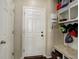 Convenient mudroom featuring white door, built-in bench, and storage shelves at 26881 E Roxbury Pl, Aurora, CO 80016