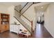 Elegant staircase with wooden banister and carpeted steps, seamlessly connecting floors at 26881 E Roxbury Pl, Aurora, CO 80016