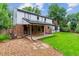 A nice backyard featuring a stone and gravel path, lush lawn, mature trees, and a covered patio at 7873 E Colgate Pl, Denver, CO 80231