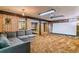 Recreational room in the basement with stone accent wall and a pool table in the background at 7873 E Colgate Pl, Denver, CO 80231