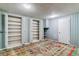 Finished basement with bright rug, ample shelving and painted wood walls at 7873 E Colgate Pl, Denver, CO 80231