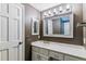 Bathroom featuring a large decorative mirror and ample counter space at 7873 E Colgate Pl, Denver, CO 80231
