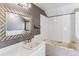 Bathroom with tub, integrated shower and vanity with a large mirror at 7873 E Colgate Pl, Denver, CO 80231
