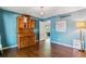 Elegant dining room with vintage hutch, hardwood floors, and stylish chandelier at 7873 E Colgate Pl, Denver, CO 80231