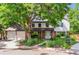 Charming two-story home with landscaped yard and large shade tree covering the home at 7873 E Colgate Pl, Denver, CO 80231
