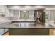 Bright kitchen features stainless appliances, marble countertops, and ample natural light at 7873 E Colgate Pl, Denver, CO 80231