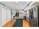 Open kitchen with island, stainless steel appliances, and hardwood flooring at 7873 E Colgate Pl, Denver, CO 80231