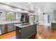 Spacious kitchen features a large island, stainless steel appliances, and hardwood floors at 7873 E Colgate Pl, Denver, CO 80231