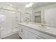 Bathroom featuring double sinks, ample counter space, and a glass enclosed walk in shower at 837 Ledge St, Lochbuie, CO 80603