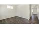 Bright, vacant room featuring sleek hardwood flooring, a window, and neutral white walls at 837 Ledge St, Lochbuie, CO 80603